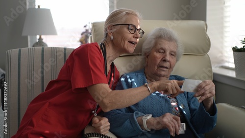 A caregiver engages with a senior resident at a memory care facility, focusing on a card during an afternoon activity. Both are involved in a meaningful exchange.
