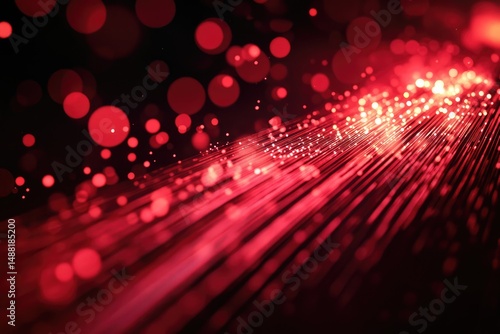 Abstract image of red light trails and bokeh on a dark background, creating a luminous and magical effect.