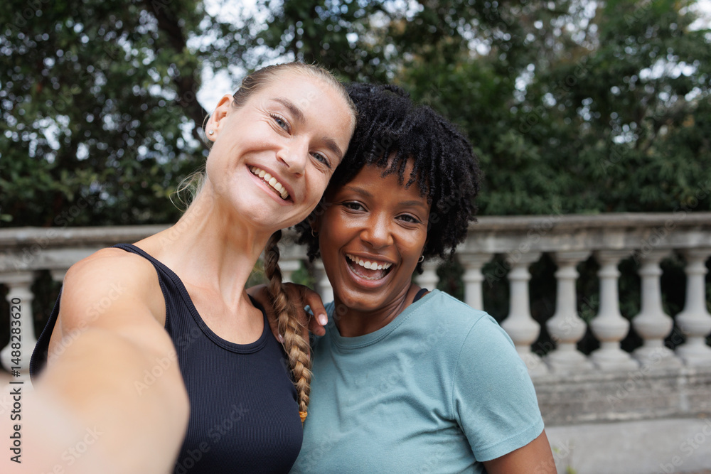 Naklejka premium portrait of lesbian couple multiracial black and caucasian women together in selfie photo