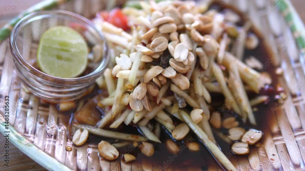 Thai Fermented Papaya Salad with Crab – Close-up of Som Tum Pu Pla Ra Served with Lime and Peanuts Thai Fermented Papaya Salad with Crab – Close-up of Som Tum Pu Pla Ra Served with Lime and Peanuts