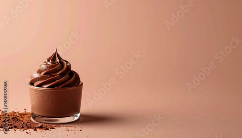 against a simple, solid color background, the scene features a clear glass container holding a generous serving of a creamy, dark colored dessert