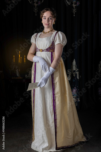 A Regency woman wearing evening attire and holding a letter