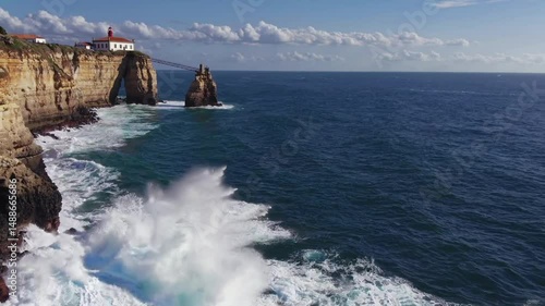 Majestic cliffs embrace the ocean. A lighthouse stands sentinel on the edge of the world while waves crashing against the cliffs create a dramatic spectacle. 