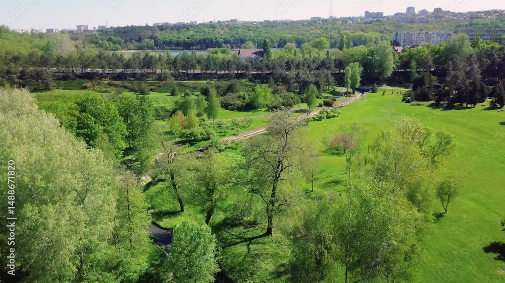Green urban park with trees and river – drone shot Green urban park with trees and river – drone shot