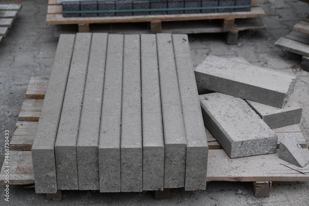 Fototapeta premium Edging stones on a wooden pallet on a building site, infrastructure sector