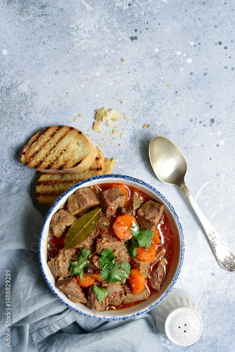 Goulash (meat stew with tomatoes and paprika) - traditional dish of hungarian cuisine .Top view with copy space.