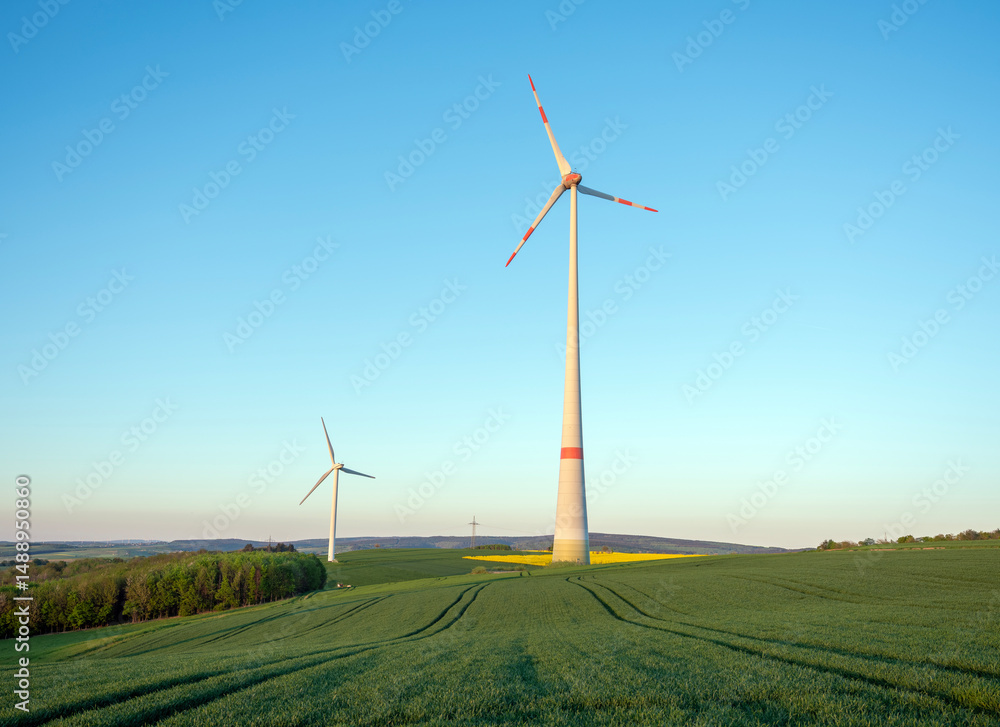 Obraz premium wind turbines under blue sky in german saarland in spring