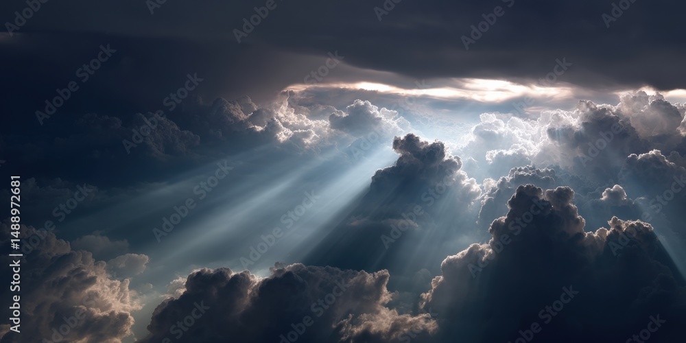 Obraz premium Heavenly rays of light pierce through a dramatic, dark sky filled with fluffy clouds. A breathtaking view from above.
