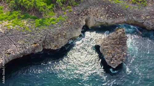 Aerial view of Angel’s Billabong in Bali, Indonesia, where tide pools form a scenic natural infinity pool in dramatic rocky terrain.
