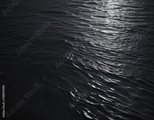 Dark water, subtle ripples create a mesmerizing texture on a still, dark surface ,  black,  water,  mysterious