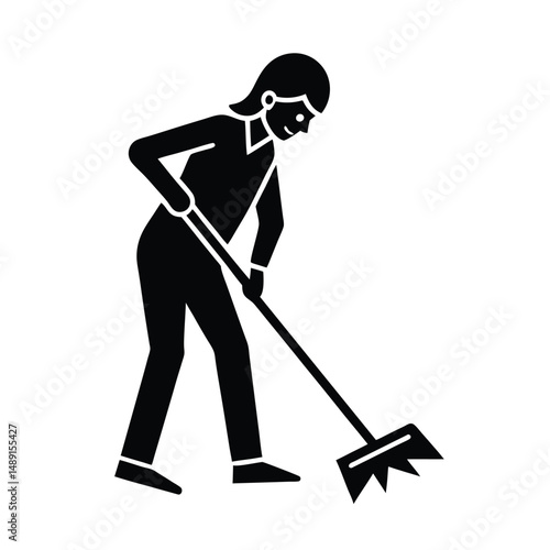 Woman silhouette using a garden rake