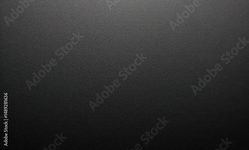 Textured black surface with subtle patterns and a matte finish.
