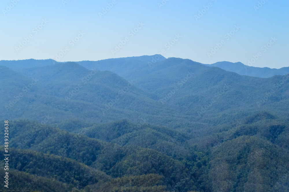 Fototapeta premium Distant Mountains and Forest with Trees and Sky in Northern Thailand.