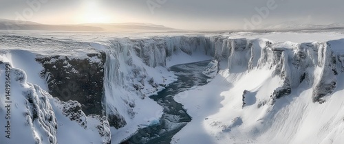Wallpaper Mural A wide snowy canyon with steep cliffs carved by a winding river under a soft, diffused light creating a serene and cold winter atmosphere Torontodigital.ca
