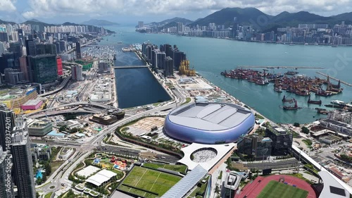 Hong Kong Kai Tak Sports Park includes a world-class multi-purpose main venue with retractable canopy and coastal dining area by seaside Victoria Harbour connected Station Metropolitan Park