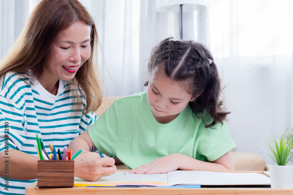 Asian mother and young daughter coloring, playing together bonding relationship family, mom multitasks and child share free time joyful drawing, teaching schoolwork with little girl, homeschool kid Asian mother and young daughter coloring, playing together bonding relationship family, mom multitasks and child share free time joyful drawing, teaching schoolwork with little girl, homeschool kid