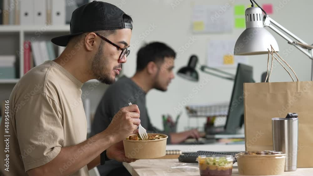 Man eating healthy meal while working, Businessman having a lunch break at the office