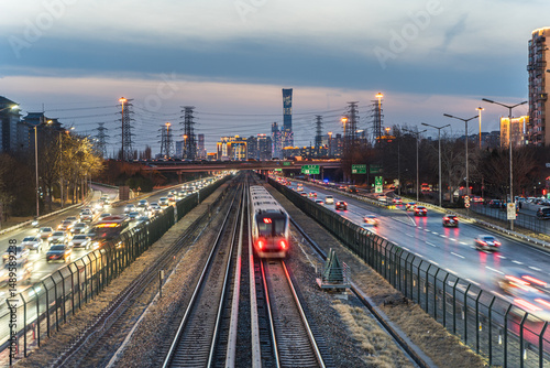 The urban evening rush hour of rail transit and vehicle flow at night in Beijing, China