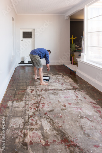 renovation project, painting a waterproofing layer on an old floor