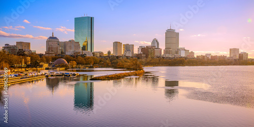 Fototapeta Boston city panoramic skyline over the Charles River in Massachusetts, USA—a tranquil riverscape of Back Bay with golden autumn foliage glowing at sunrise in the heart of New England