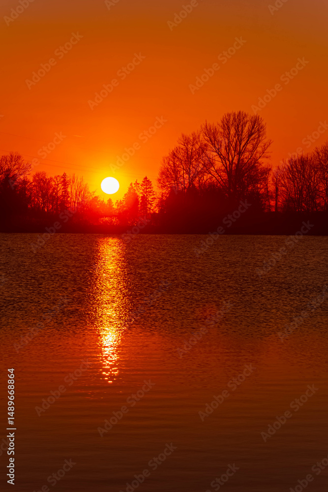 Fototapeta premium Spring sunset or sundowner view with reflections near Plattling, Isar, Deggendorf, Bavaria, Germany