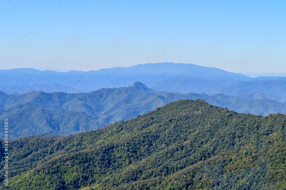 Fototapeta premium Distant Mountains and Forest with Trees and Sky in Northern Thailand.