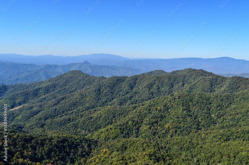Fototapeta premium Distant Mountains and Forest with Trees and Sky in Northern Thailand.