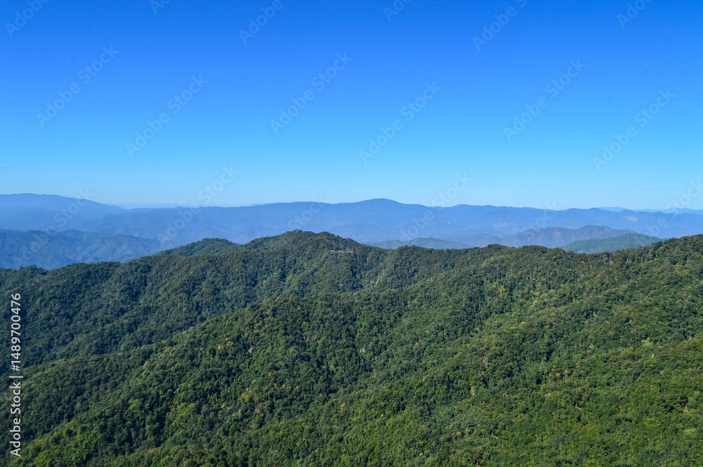 Obraz premium Distant Mountains and Forest with Trees and Sky in Northern Thailand.