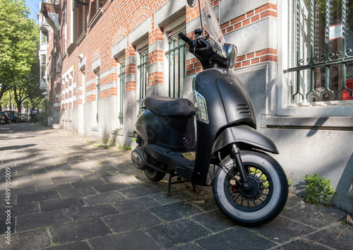 Obraz na płótnie Scooter moto parked on road side, in front of a building, Netherlands Holland w salonie