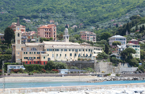 Liguria and old traditional building, church. Recco town by sea. Panoramic view with mountain. Tourism and vacation.