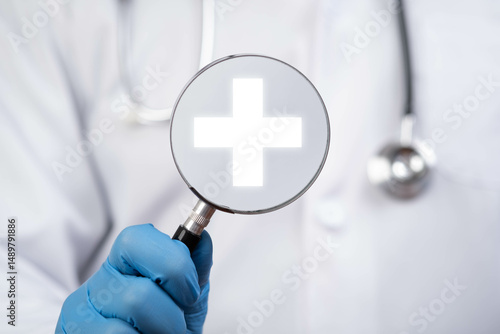 Фотография A medical professional holds a magnifying glass showing a health symbol, emphasizing the importance of healthcare and attention to detail in medicine