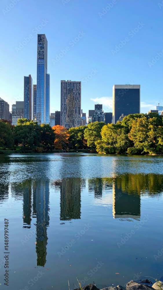 Reflections of Modern City Skyline in Calm Lake Surrounded by Park Reflections of Modern City Skyline in Calm Lake Surrounded by Park