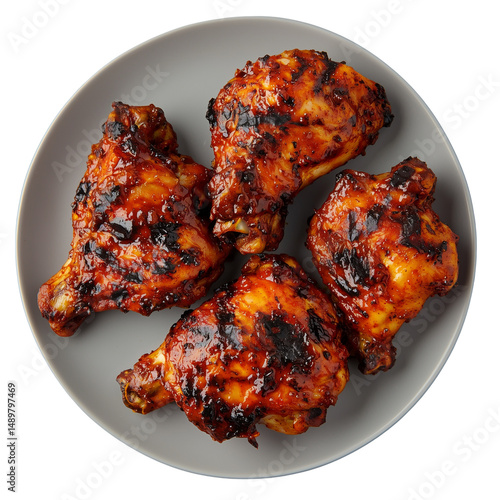 Grilled Piri Piri Chicken, thighs on a plate, showcasing a dark, charred glaze and juicy texture. isolated on white background and transparent background