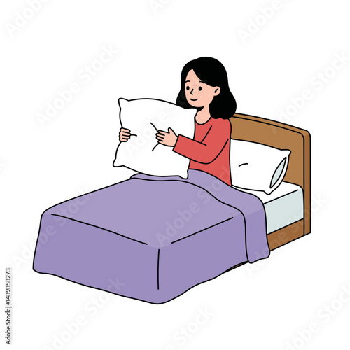 Girl happily arranging pillow on the bed while sitting in pajamas