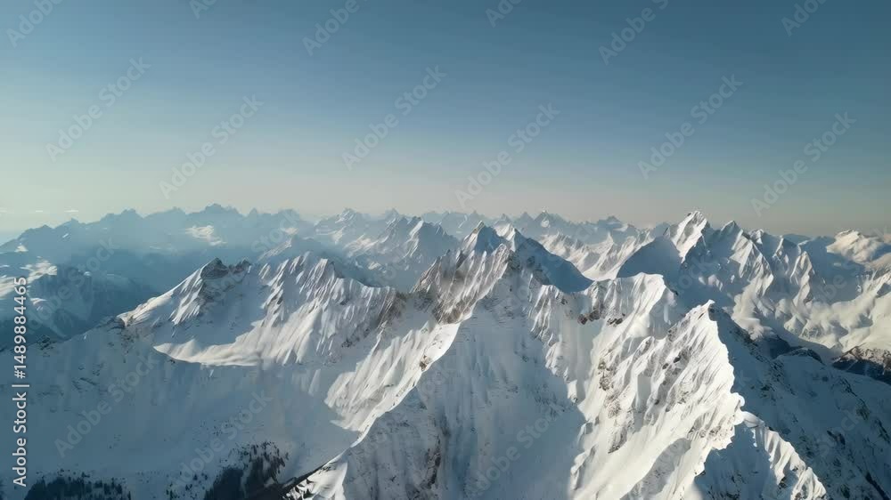 Winter mountain range under a clear blue sky covered in snow, creating a beautiful alpine landscape scene for nature enthusiasts Winter mountain range under a clear blue sky covered in snow, creating a beautiful alpine landscape scene for nature enthusiasts