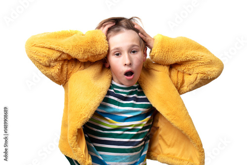 Teenage boy with surprise or indignation emotion posing in yellow jacket. He is wearing striped shirt.