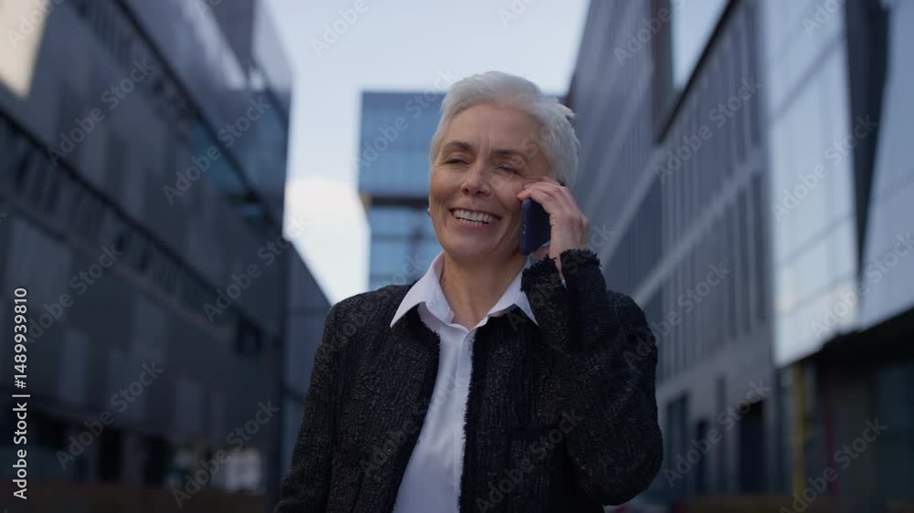 Smiling Senior Woman Walking and Talking on Phone Smiling Senior Woman Walking and Talking on Phone