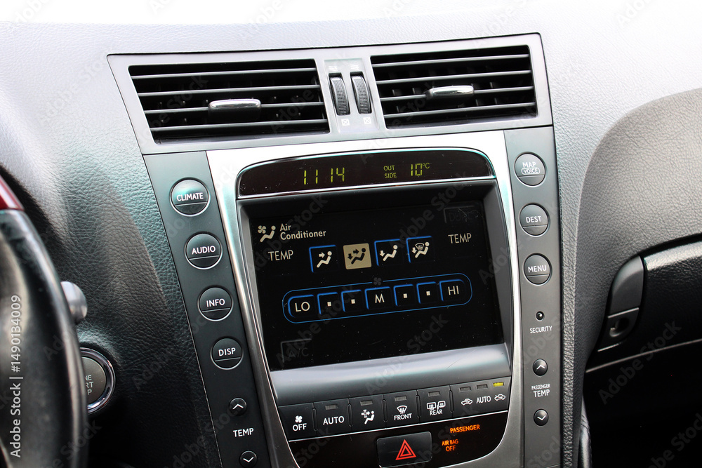 Fototapeta premium Old car multimedia system screen. Dashboard in a modern classic car. Control Panel of a old business car. Climate control old car. Conditioner in lux sedan.