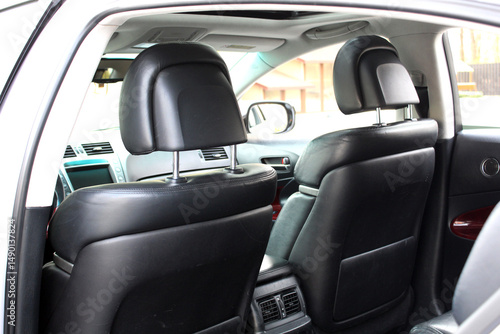 Close-up of the front seat back of a lux car. Front drivers and passenger seat back of matte black genuine leather inside the interior of an expensive luxury sedan. Leather back passenger seats. 