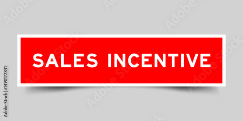 Red color square shape sticker label with word sales incentive on gray background