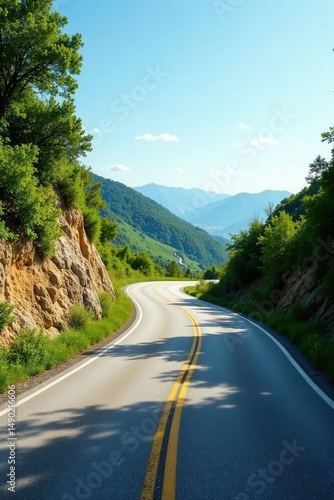 Scenic Winding Road Through Lush Green Mountain Landscape Under a Clear Sky