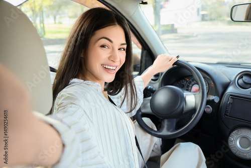 Happy young woman taking se...