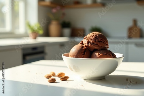 Delicious Chocolate Ice Cream Scoops in a Bowl with Almonds on a Sunny Kitchen Counter