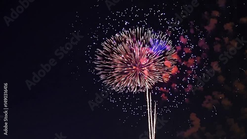 Aerial view of colorful fireworks over a city skyline at night, festive atmosphere. Ideal for a celebratory video, 4th of July, New Year, Independence Day