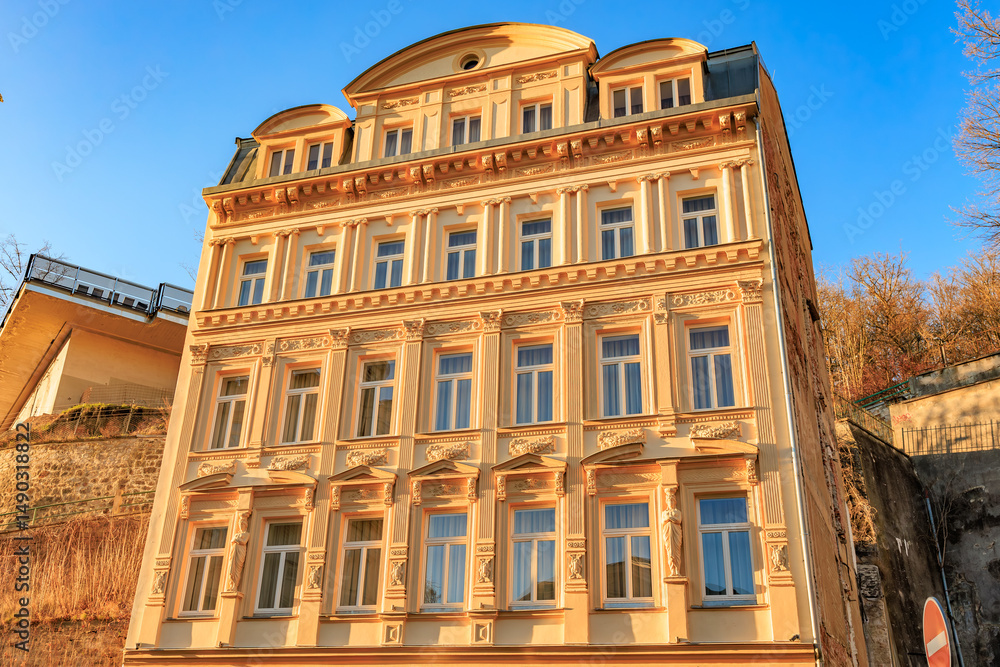 Fototapeta premium Historic european building with ornate facade in warm sunlight