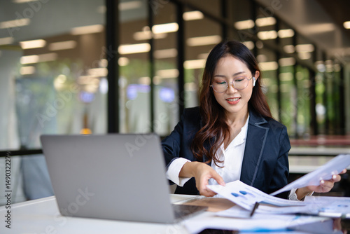 Asian businesswoman working on financial market research using laptop and digital tablet about digital investment in office. Free Download Asian businesswoman working on financial market research using laptop and digital tablet about digital investment in office. - GFXLoad