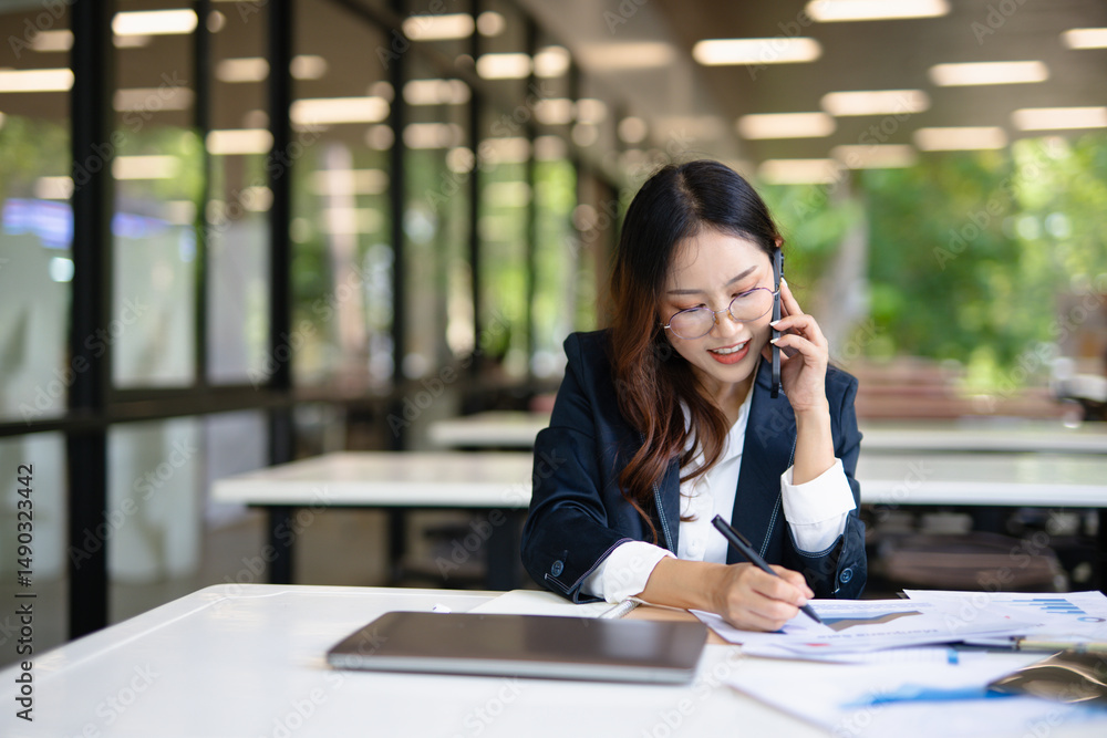 Asian businesswoman doing financial market research using laptop and digital tablet on digital investment in front of modern office. Asian businesswoman doing financial market research using laptop and digital tablet on digital investment in front of modern office.
