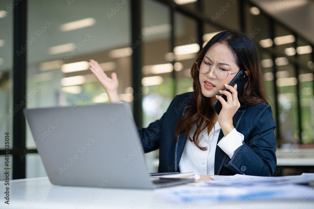 Asian businesswoman working on financial market research using laptop and digital tablet, stressed about digital investment in office. Asian businesswoman working on financial market research using laptop and digital tablet, stressed about digital investment in office.