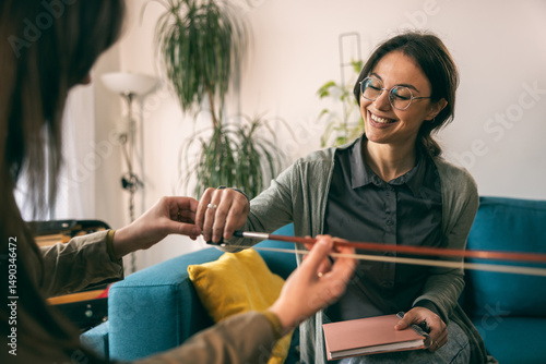 Music Teacher Explaining Violin To Student