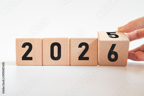 Hand-turned wooden cube from 2025 to 2026. New business goal strategy concept. 2026 goal planning business concept